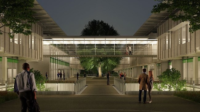 Rendering of a glassed-in walkway between two parts of the SNF General Hospital of Komotini illuminated at night