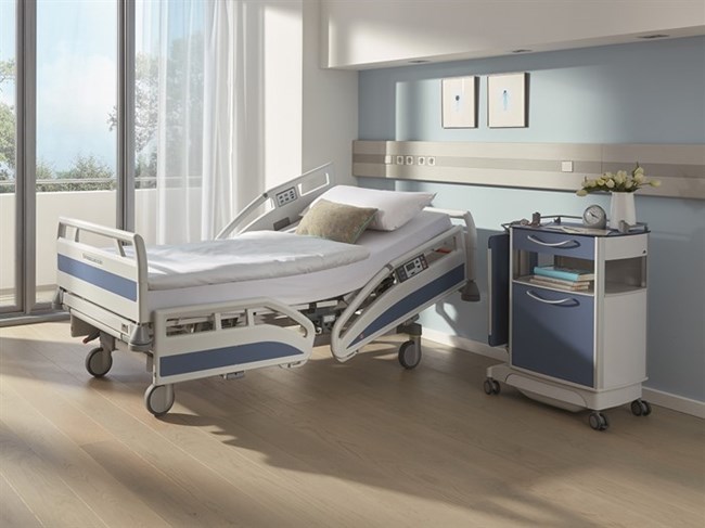 A rendering of a hospital bed and side table in a sunlit hospital room